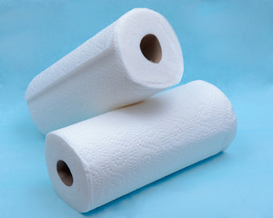 Soft strong and absorbent paper towel isolated on blue under pad.