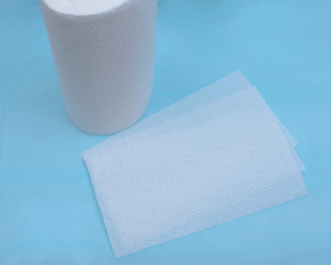 Soft strong and absorbent paper towel isolated on blue under pad.