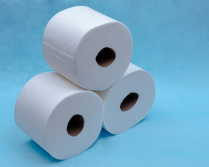 Soft strong and absorbent white toilet paper isolated on blue under pad.