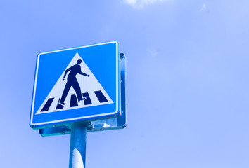 Traffic light on blue sky back ground. A man cross road signal traffic.