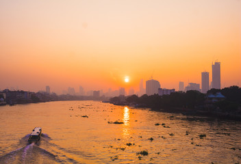 In the morning sunrise in to sky. Early morning sunrise over the river and building. Photo landscape Bangkok Thailand.