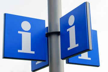 Blue information signs on a pole