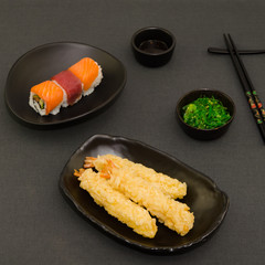 Traditional japanese food. Sushi and fried tempura prawns, with seaweed salad