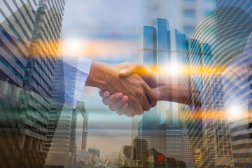 Fototapeta na wymiar Double exposure picture. Picture mix building city and Shake hands. They are Shake hands mean teamwork and spirit beside building background. Photo concept for success and team work.
