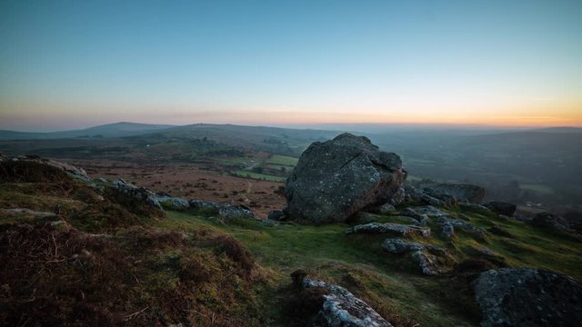 Time lapse of sunset painting landscape gold, Dartmoor National Park, UK