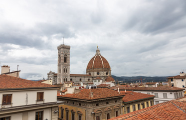 Fototapeta premium View of the Cathedral of Santa Maria - Del - Fiore and the Giotto's bell tower from the rooftops in Florence, Italy