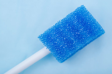 Untreated disposable oral swabs on blue under pad.