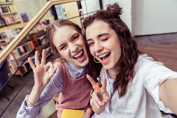 Appealing ladies actively gesturing during selfie for social media - Powered by Adobe