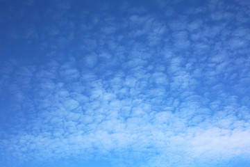 Blue sky background with clouds and copy space.
