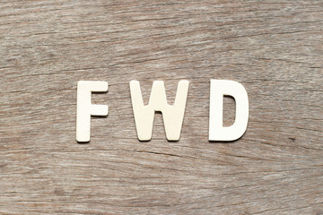 Alphabet letter in word FWD (Abbreviation of forward) on wood background