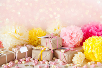 Gifts and pink decorations for girl baby shower indoors.