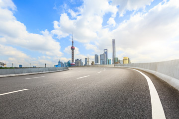 Fototapeta na wymiar Asphalt road passes through Shanghai Lujiazui Financial District