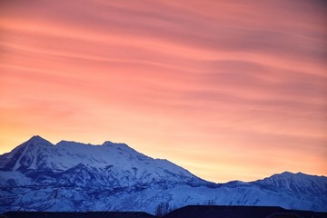 Fototapeta na wymiar Sunrise of Winter panoramic, view of Snow capped Wasatch Front Rocky Mountains, Great Salt Lake Valley and Cloudscape from the Mountain view Corridor Highway. Utah, USA.