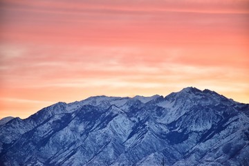 Sunrise of Winter panoramic, view of Snow capped Wasatch Front Rocky Mountains, Great Salt Lake Valley and Cloudscape from the Mountain view Corridor Highway. Utah, USA.