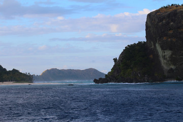 Fototapeta na wymiar Sandbank in the Sacred Islands with the mountains of the island of Yanuya in the background, Mamanuca Islands, Fiji