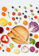 Flat lay view of different colourful raw vegan food on marble background.