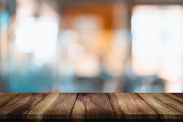 Empty wood table with blur cafe background.