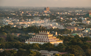 Aerial view of Atumashi monastery and Mandalay town at sunset view from Mandalay hills.
