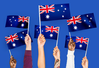 Hands waving the flags of Australia