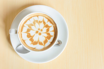 hot cappuccino coffee with nice pattern foam on table