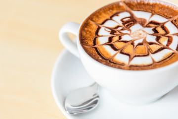 hot cappuccino coffee with nice pattern foam on table