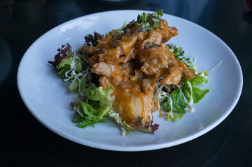 Tempura crab served with sauce and lettuce leaves