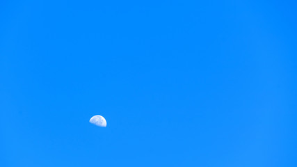 mini moon on blue sky nature background ,clear blue color , blank empty space backdrop