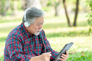 Lifestyle senior man feel happy enjoy listening to music with earphones headphones isolated on white background