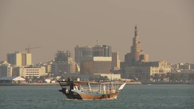 WS Dhow sailing in Doha Bay, city skyline  in background / Doha, Qatar