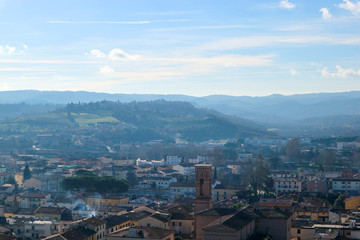 aerial view of the tuscany city Certaldo in morning winter fog with hills on the background, Italy