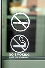 No Smoking sign on the glass window of a building