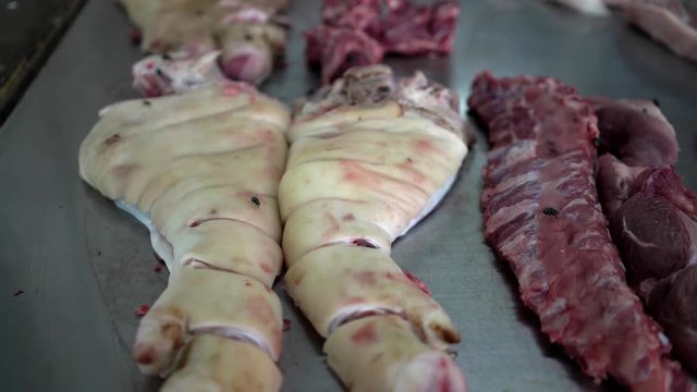 meat in flies on the market.  sitting on the meat. Unhygienic meat