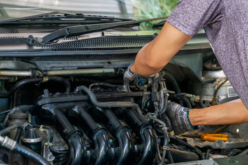 Auto mechanic repairing car. Selective focus in Thailand