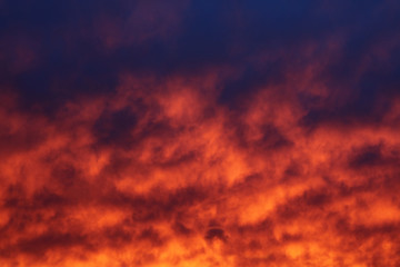 The sky and brightly illuminated clouds at sunset as the background for the design.