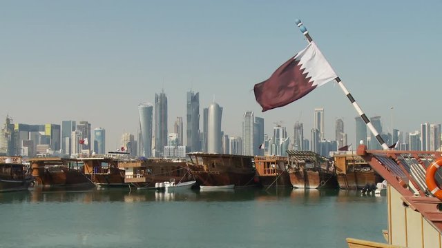 WS ZO Dhows moored in marina with city skyline in background / Doha, Qatar
