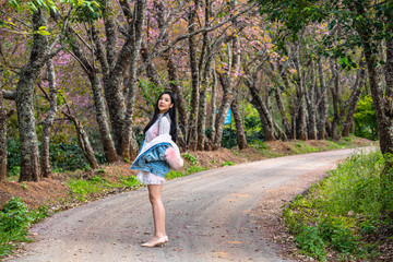 Fototapeta premium Beautiful young teenage girl posing under a trees.