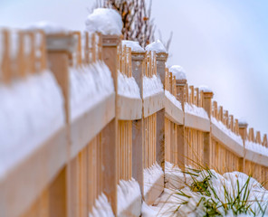 Snow covered wooden fence during winter in Utah