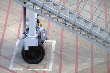 Closeup of wheel and stairway of air bridge, parking at the designed position at airport
