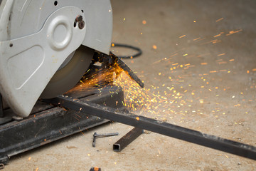 Image of worker using a sliding compound mitre saw with circular blade for cutting