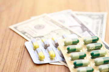 medicine pill pack with dollar money 