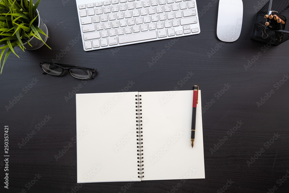 Poster flat lay of top view modern black wood desk work table with computer laptop and stationary in home o