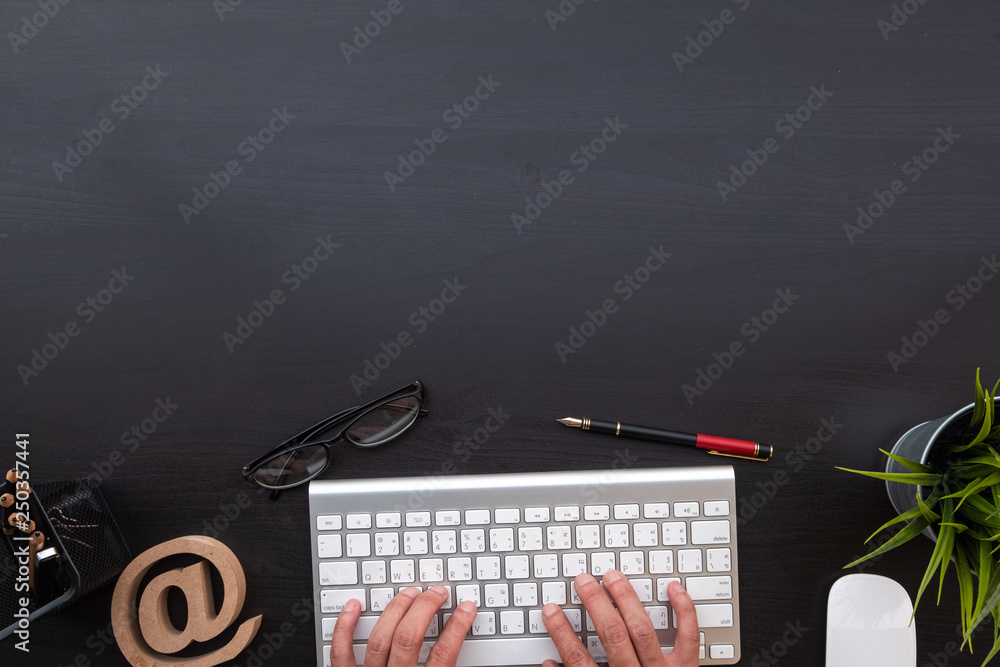 Poster flat lay of top view modern black wood desk work table with computer laptop and stationary in home o