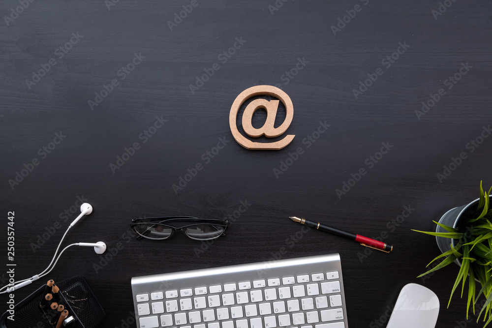 Poster flat lay of top view modern black wood desk work table with computer laptop and stationary in home o