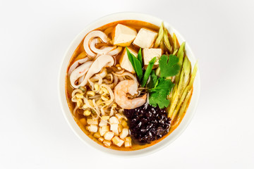 Seafood and noodle soup shot on white background