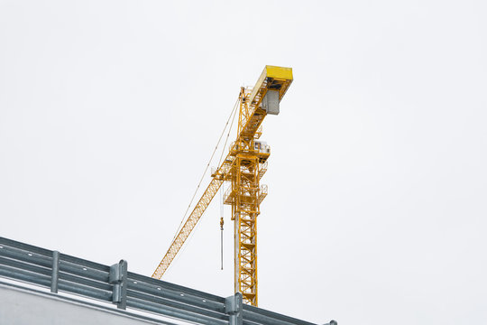 Multi-storey construction. Crane on white background. Copy space.