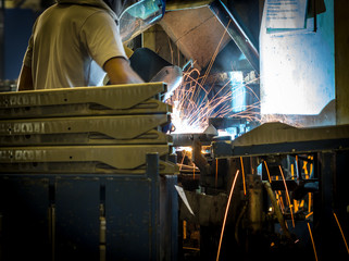 Welder, iron in a factory