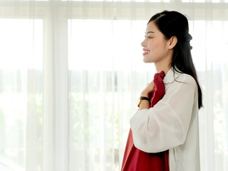Happy Asian woman showing her new dress, just received from online delivery service, modern lifestyle concept.