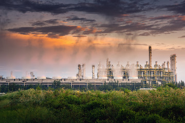 Naklejka premium Cooling Tower of Oil and Gas Refinery Plant at Sunset. Process Buildings of Petrochemical Manufacturing., Business Engineering and Power Energy, Chemical and Petroleum factory.