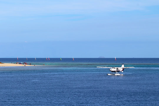 A seaplane and windsurfing in an island of Mamanuca, Fiji
