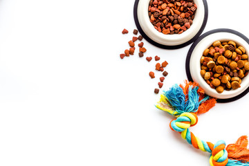 Animal food in bowl on white background top view copy space